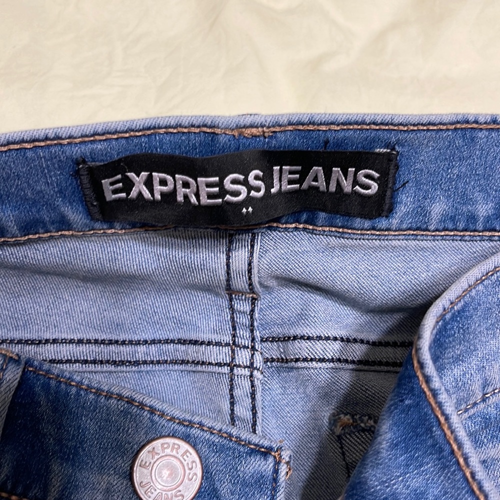 Like new. Ripped Express jeans. Washed blue.